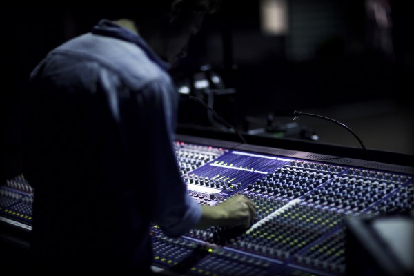 Sound engineer mixing the audio behind the audio console. Denmark 2011. (Photo by: PYMCA/UIG via Getty Images)